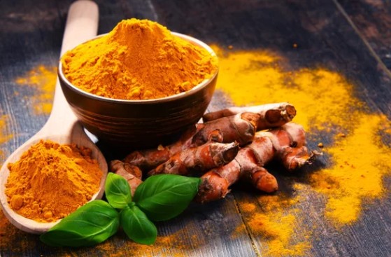 Fresh and dried turmeric in a bowl.