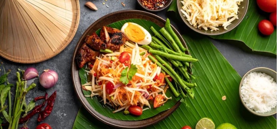 Thai-style green and yellow papaya salad with egg and chicken