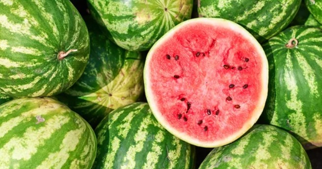 Whole watermelons with one sliced open
